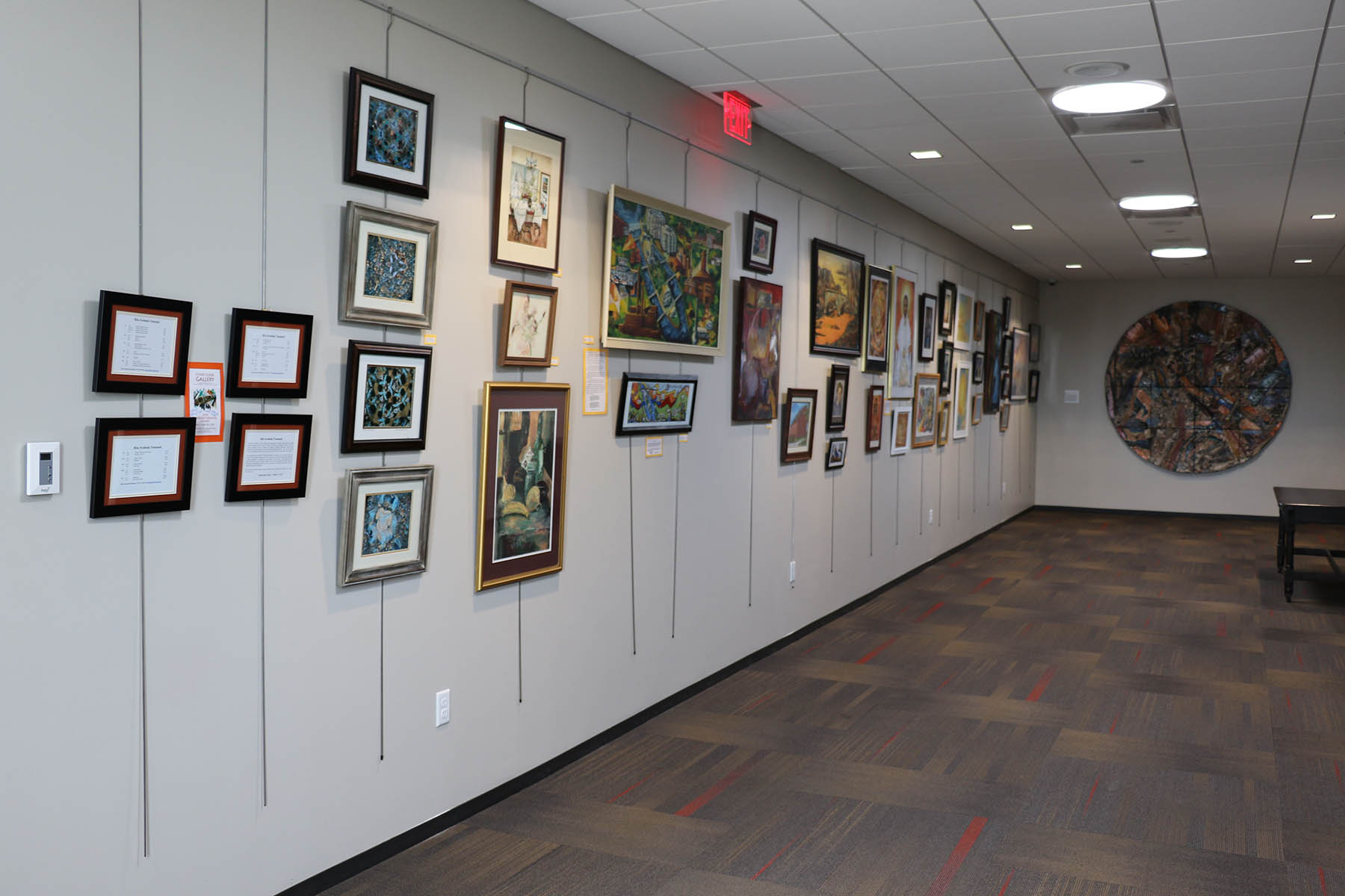 Artwork on display on the third floor gallery wall in the Downtown Library
