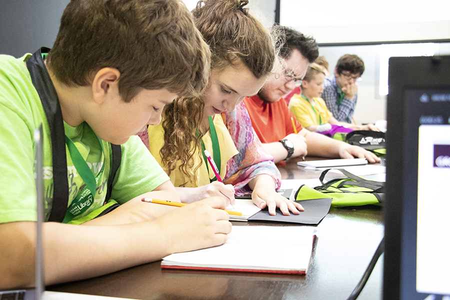 Students sitting at table with pencils and paper