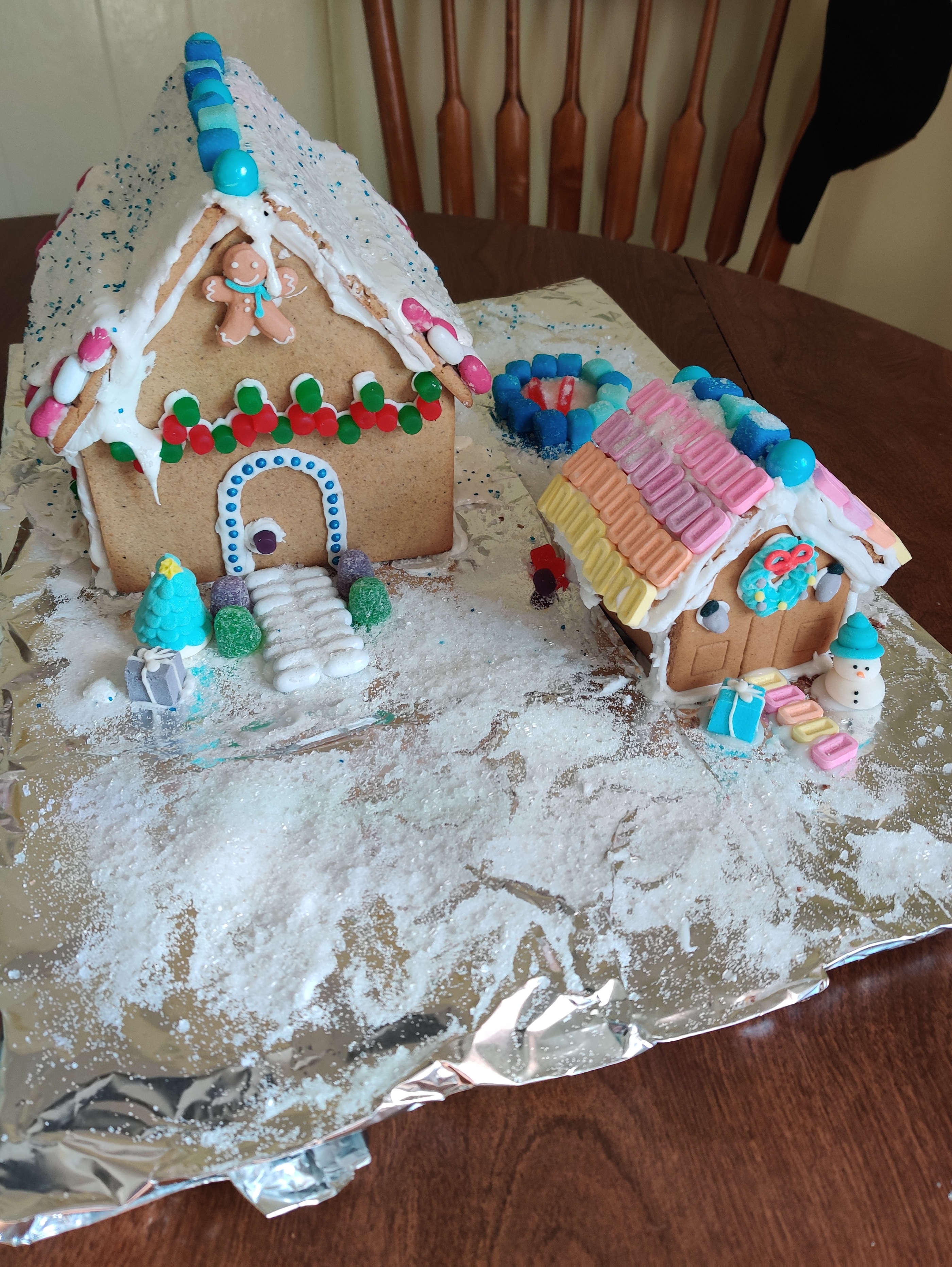 A gingerbread house sits with an ADU with a Pez roof.