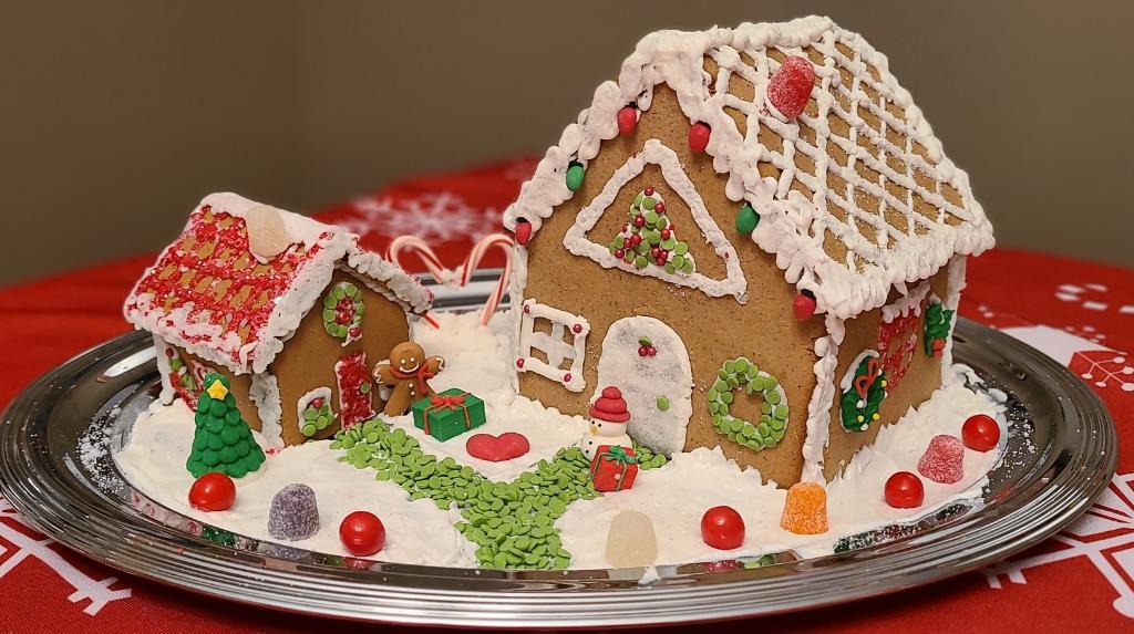 A gingerbread house is connected to an ADU with a green candy path.