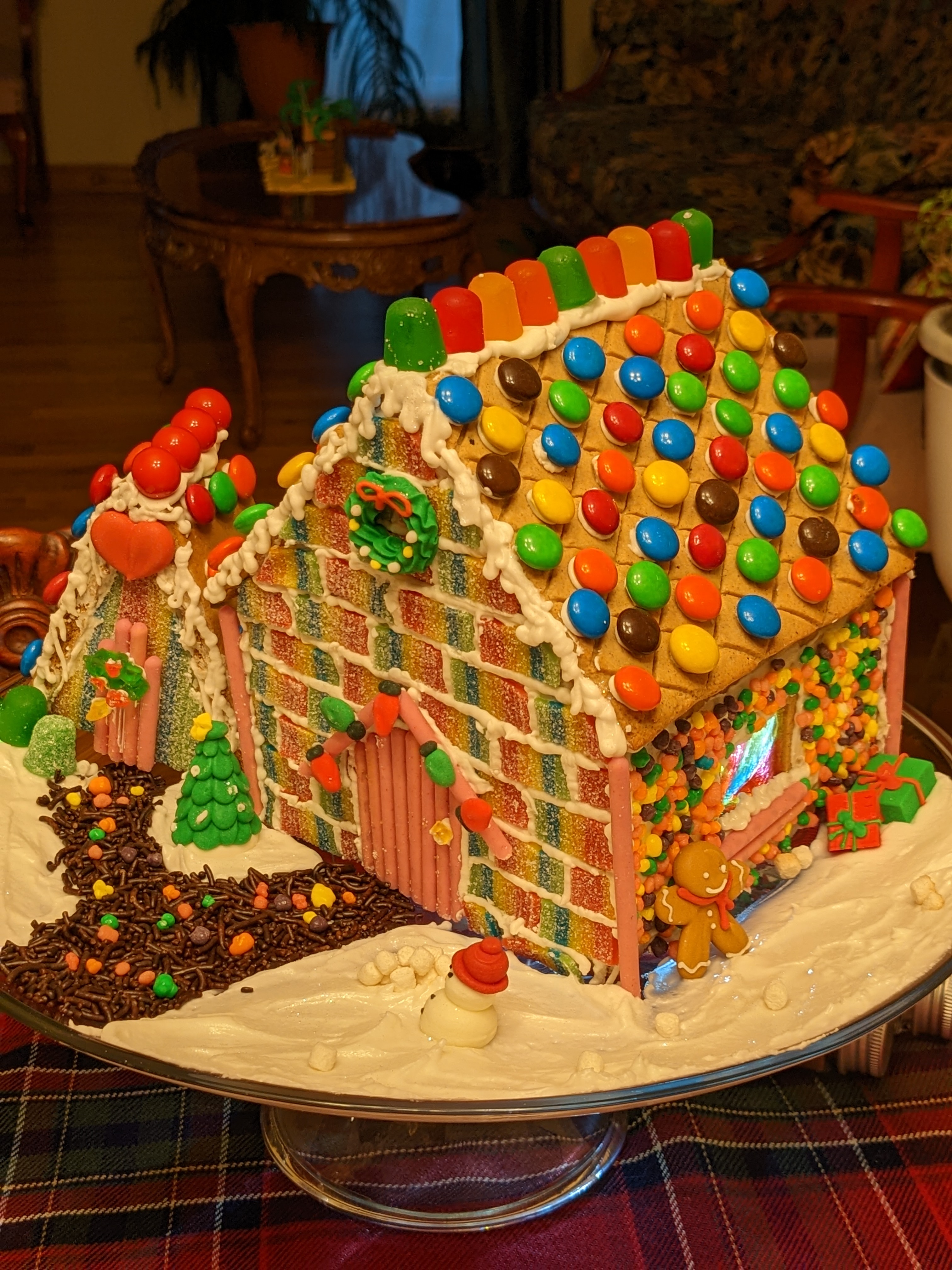 A gingerbread house with colorful candy on the roof and walls.