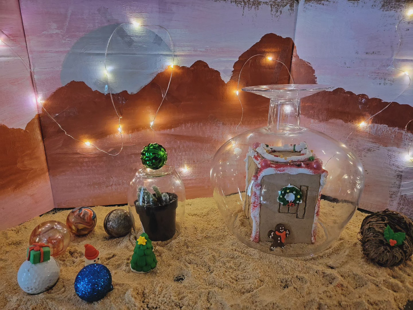 A gingerbread library is inside a glass dome with a painted Mars backdrop.