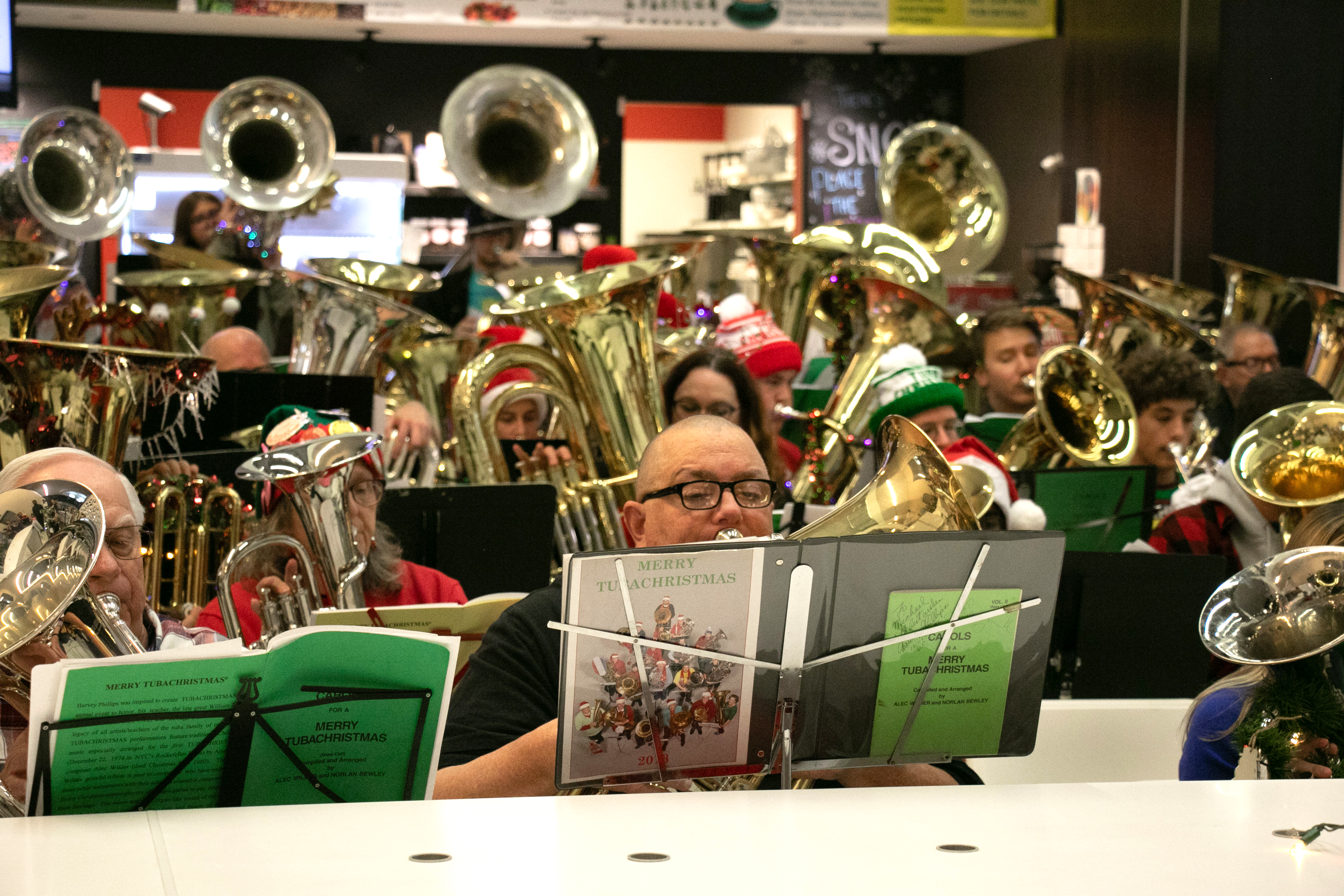 A large group plays tubas in the Downtown Library.