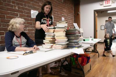 volunteers working a table at the friends of the library book sale 