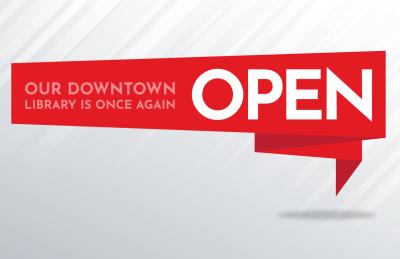 A red banner with the words "Our Downtown Library is Once Again Open."