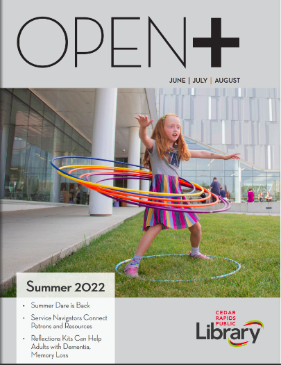 A girl hula hoops in front of the library on the cover of OPEN+ magazine.