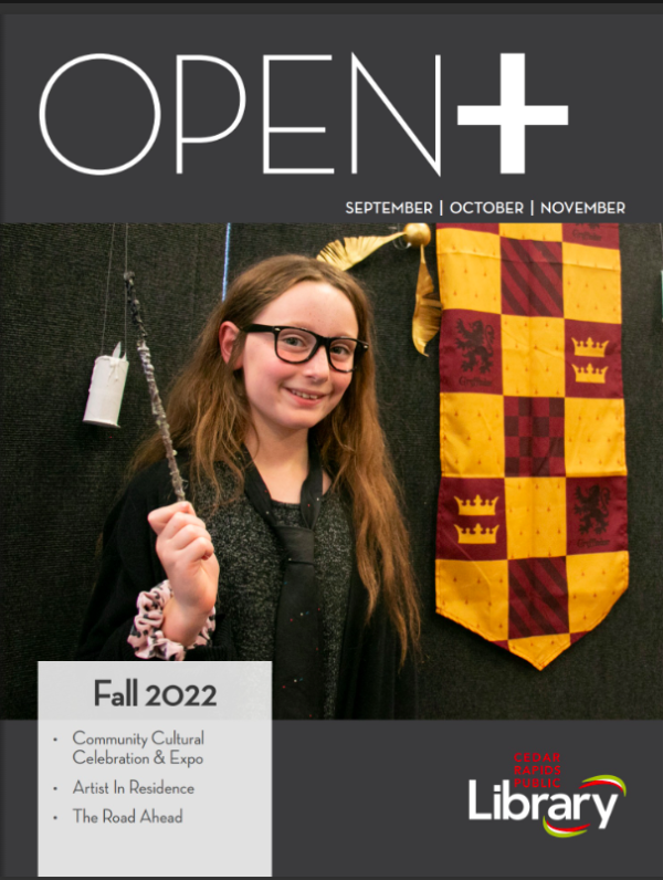 A girl in a Harry Potter costume with black robe, glasses and a wand smiles on the cover of OPEN+ magazine.