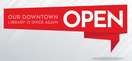 A red banner with the words "Our Downtown Library is Once Again Open."