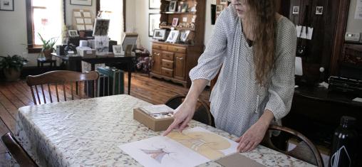 Missa Coffman points to a stencil she created in the library's Maker Spaces in her shop, Tree of Liminality.