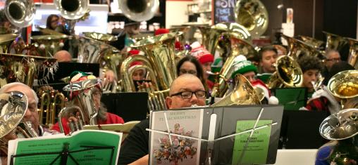 A large group plays tubas in the Downtown Library.