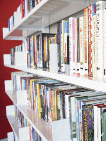 A close up of books on the library shelves.
