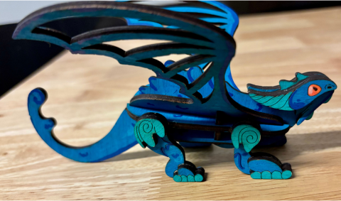 Wooden dragon painted blue and light green