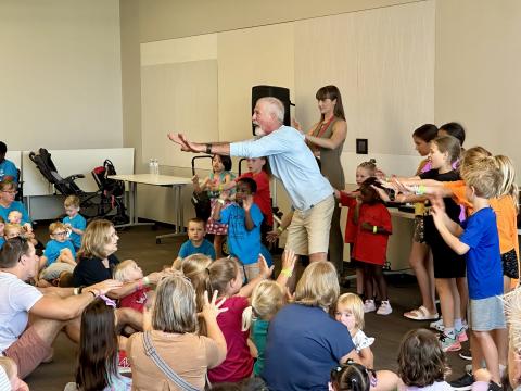 Tom Pease and children dance at the Downtown Library.