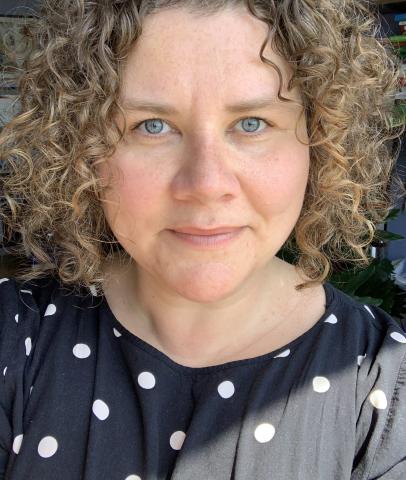 A woman, Dr. Abby M. Dubisar, looks at the camera.