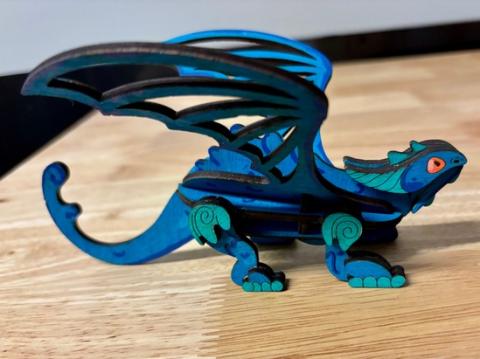 Picture of a blue laser-cut dragon.