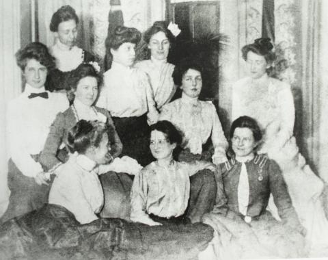 A black and white photo shows a group of 10 women, an early staff photo of the Cedar Rapids Public Library, in the early 1900s.