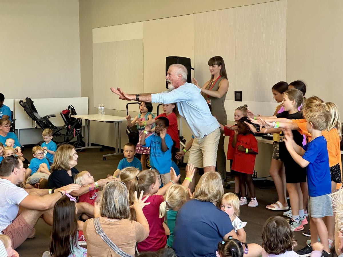 Tom Pease and children dance at the Downtown Library.