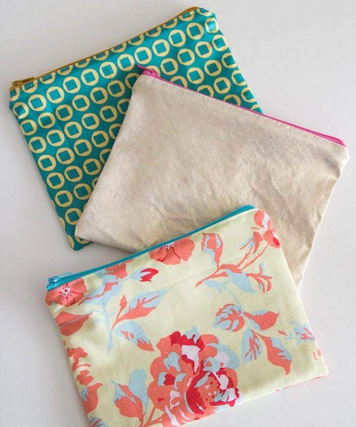three small zippered pouches in a variety of patterns