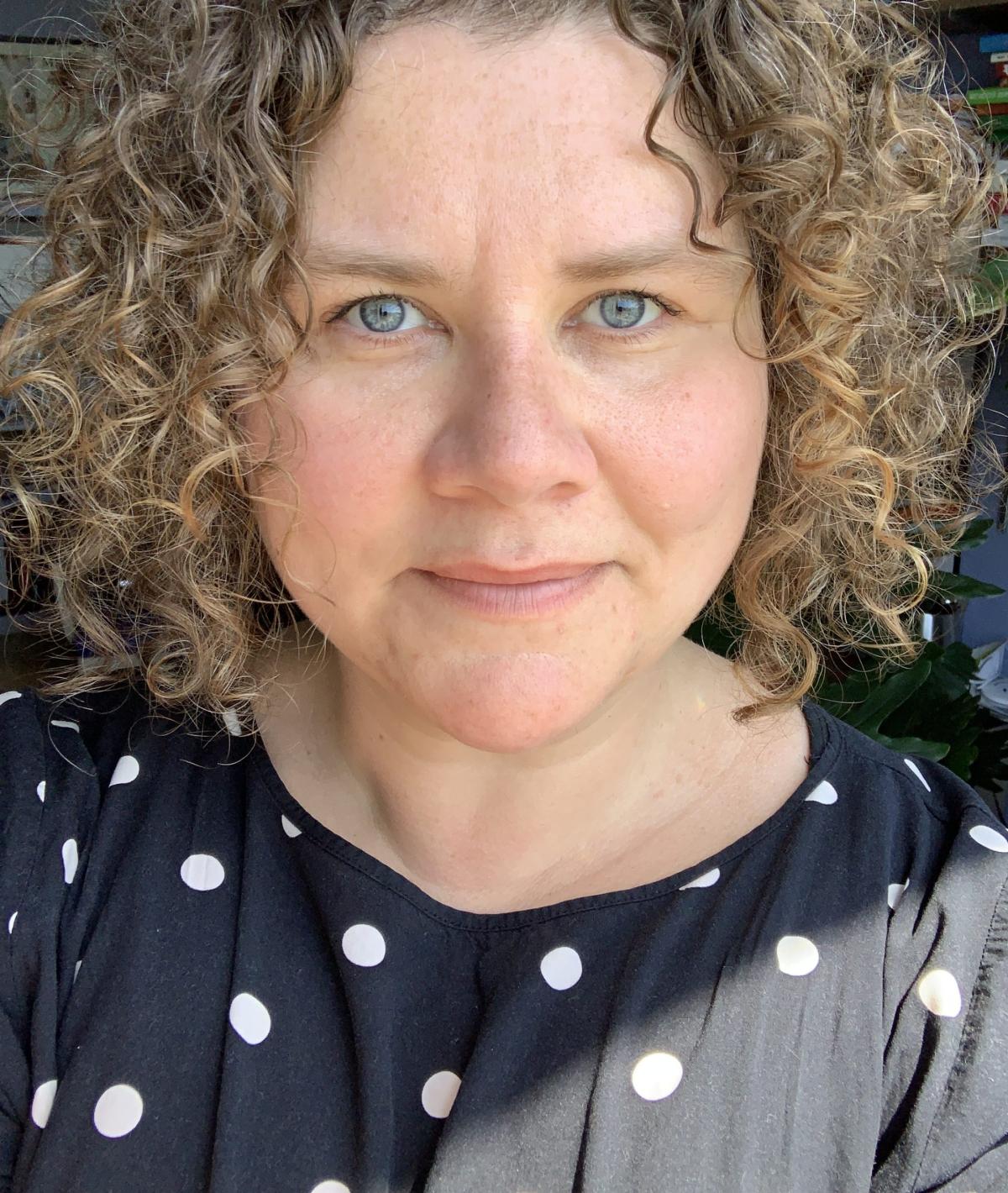 A woman, Dr. Abby M. Dubisar, looks at the camera.