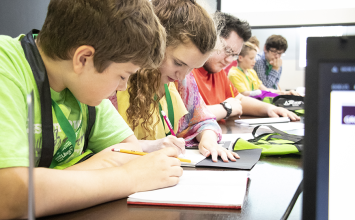 Students sitting at table with pencils and paper